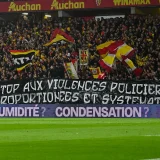 Lens Supporters Unveil Anti-Police Violence Banner During Lyon Match